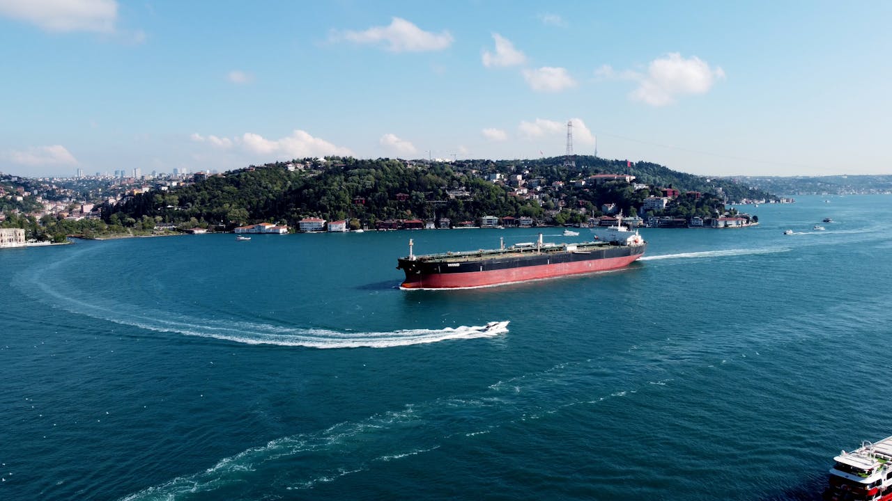 Services Aerial view of a cargo ship navigating through the Bosphorus Strait in Istanbul, Turkey.
